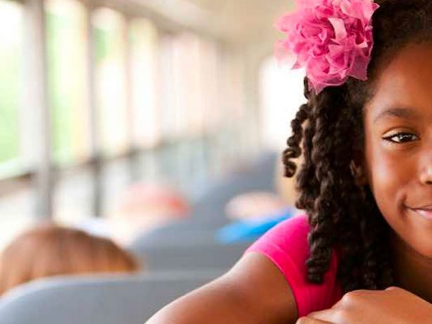 stock-children-girl-in-school-bus-smiling